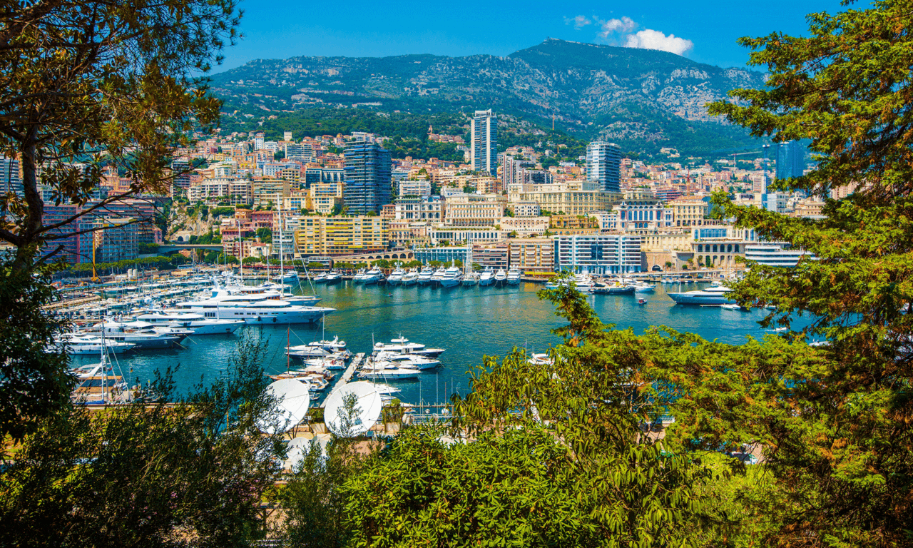 Monte Carlo cruise destination – luxury yachts in Port Hercule with city skyline and mountains in the background, perfect for solo travelers.